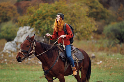 Young woman riding horse