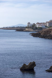 Rocks in sea against sky