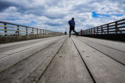 Full length of man standing on footbridge