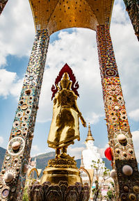 Low angle view of statue against temple building