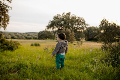 Full length of boy standing on grass