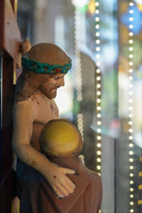 Close-up of man holding hat