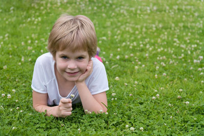 Portrait of smiling boy on grassy field