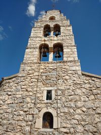 Low angle view of bell tower against sky