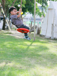 Full length of boy playing on playground