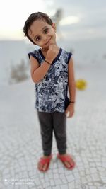 Portrait of a smiling girl standing outdoors