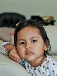 Little girl sitting on the sofa