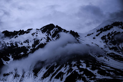 Scenic view of snow covered mountains against sky