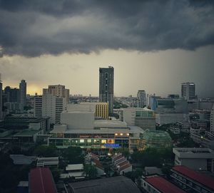 Buildings against cloudy sky