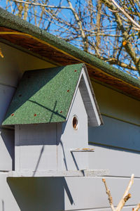 Low angle view of birdhouse on building