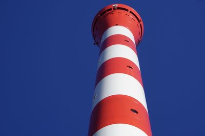 Low angle view of lighthouse against clear blue sky