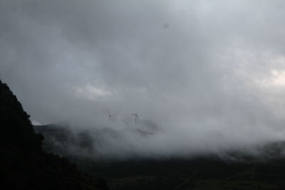 Scenic view of mountains against cloudy sky