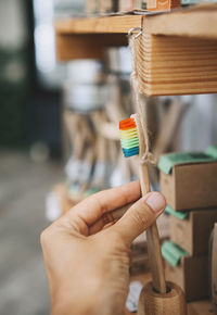 Woman picking eco-friendly wooden toothbrush from zero waste shop