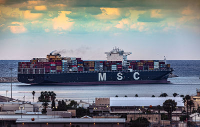 Ship at harbor against sky