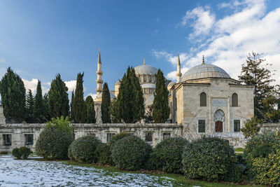 Panoramic view of trees and buildings against sky