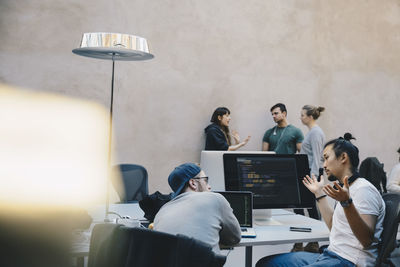 Computer programmers discussing plan in creative office