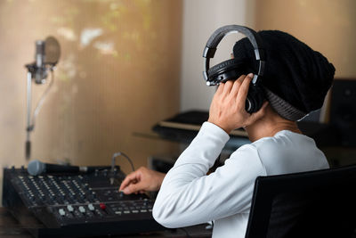 Man using sound mixer in music studio