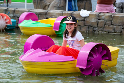 Kid playing rowing water paddle boat. soft focus. . high quality photo