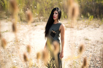 Portrait of beautiful woman standing on land