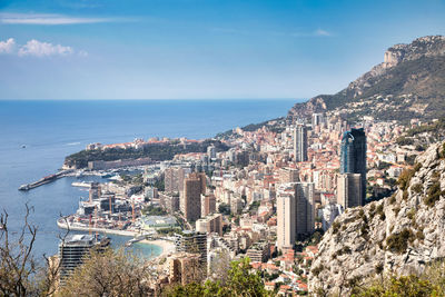 High angle view of townscape by sea against sky