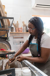 Woman washing her pottery at the ceramics studio