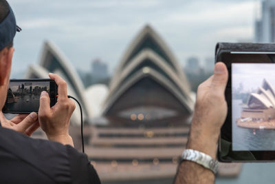 Midsection of man using mobile phone