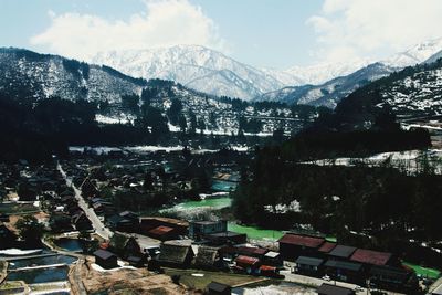 High angle view of buildings and mountains against sky