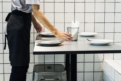 Midsection of waiter working at restaurant