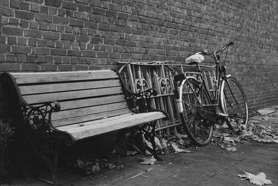 Bicycle parked against brick wall