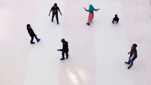 High angle view of people playing in snow