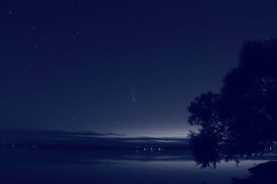Scenic view of lake against sky at night