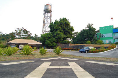 Built structure by road against sky in city