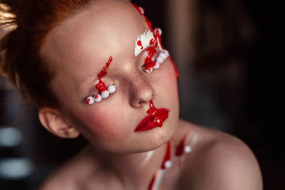 Close-up of young woman in creative makeup 