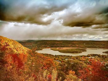 Scenic view of dramatic landscape against storm clouds