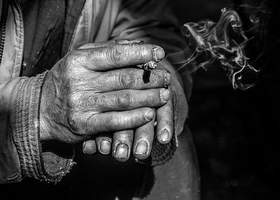 Cropped hands of man holding cigarette
