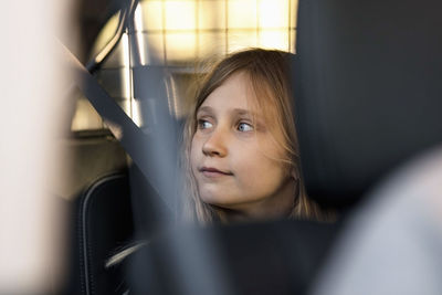 Blond girl sitting in electric car