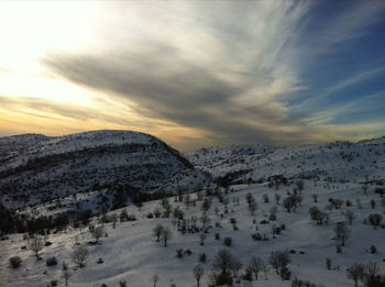 Scenic view of snow covered mountains against sky