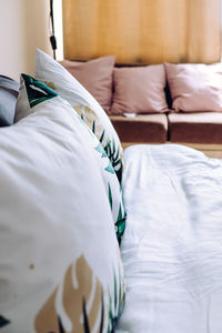 Midsection of man relaxing on bed at home