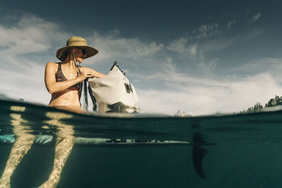 A young woman enjoys a standup paddle board on lost lake in oregon.