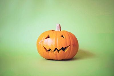 Close-up of pumpkin against green background