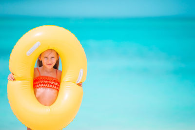 Portrait of a smiling young woman in swimming pool