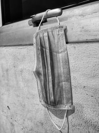 Close-up of clothes drying on clothesline against wall