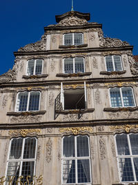 Low angle view of building against clear blue sky