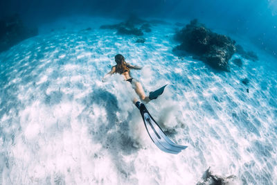 Low angle view of man swimming in sea