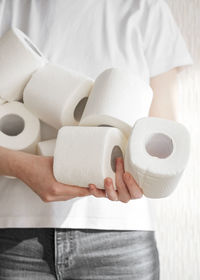 Midsection of man holding paper in bathroom