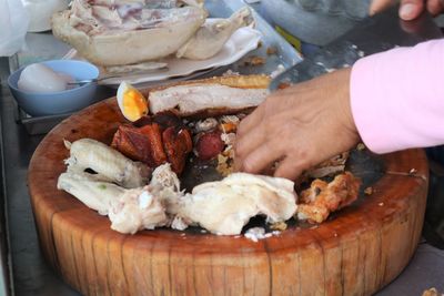 Close-up of person preparing food on table