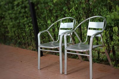 Empty chairs and table in park