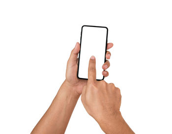 Close-up of hand holding smart phone against white background