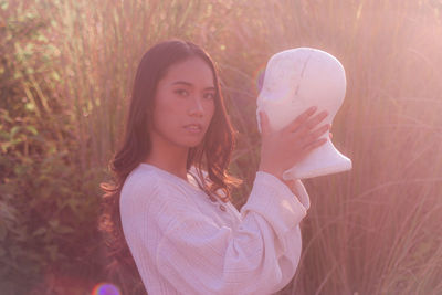 Portrait of woman holding camera