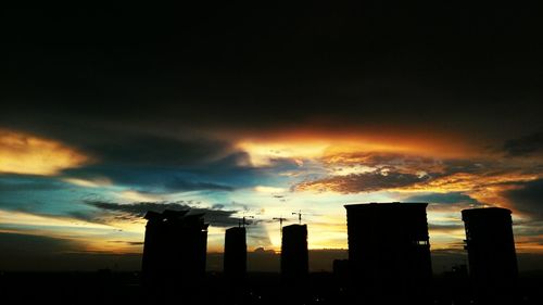 Silhouette of built structure against cloudy sky